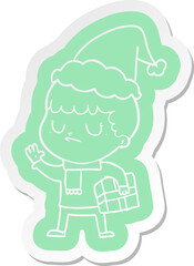 Fototapeta premium cartoon sticker of a grumpy boy wearing santa hat