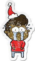 distressed sticker cartoon of a crying man wearing santa hat