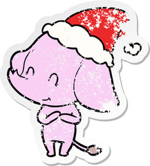 cute distressed sticker cartoon of a elephant wearing santa hat