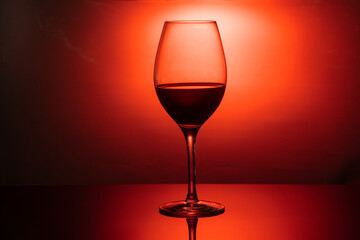 glass goblet with a drink in the back colored light, the concept of minimalism, noir style