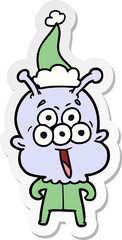 happy sticker cartoon of a alien wearing santa hat