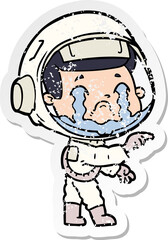 distressed sticker of a cartoon crying astronaut