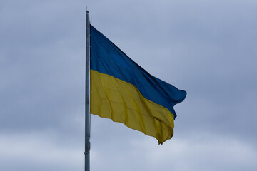 Flag of Ukraine that is developing against the background of cloudy skies