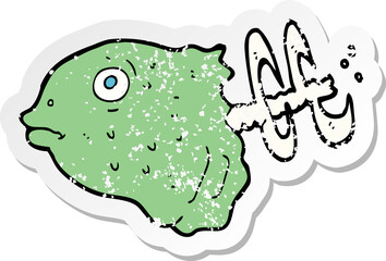 retro distressed sticker of a cartoon fish head