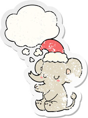 cute christmas elephant and thought bubble as a distressed worn sticker
