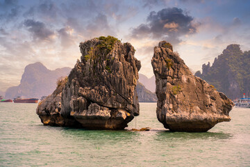 View of Hon Ga Choi Island or Cock and Hen, Fighting Cocks Island located in Ha Long bay, Vietnam, Trong Mai island, junk boat cruise and boats, popular landmark © CravenA