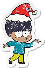nervous distressed sticker cartoon of a boy wearing santa hat