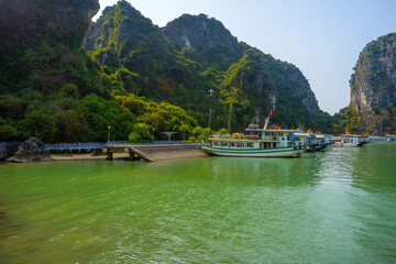 Fototapeta na wymiar View of Ha Long Bay; with a lot of limestone islets and cruise ships; on a blue sky summer day.