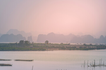 Naklejka premium View of Ha Long Bay, Quang Ninh province, Vietnam with a lot of limestone islets in morning misty, on summer day.