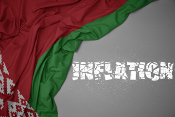 waving colorful national flag of belarus on a gray background with broken text inflation. 3d illustration