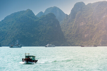 View of Ha Long Bay; with a lot of limestone islets and cruise ships; on a blue sky summer day.