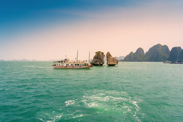 View of Ha Long Bay; with a lot of limestone islets and cruise ships; on summer day.