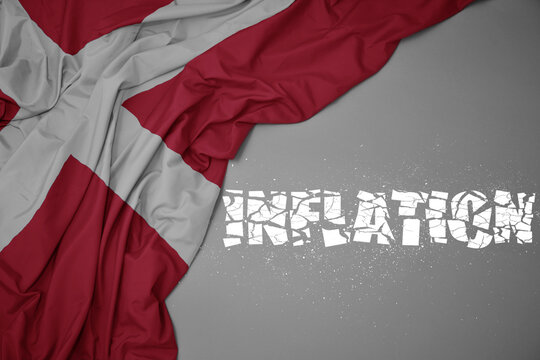waving colorful national flag of denmark on a gray background with broken text inflation. 3d illustration