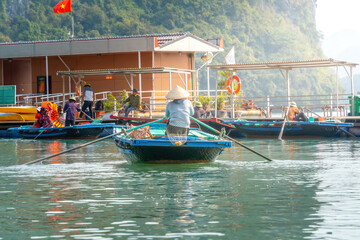 Fototapeta na wymiar view of floating fishing village and rock island, Ha Long Bay, Vietnam, Southeast Asia. Life, people and nature in Ha Long Bay