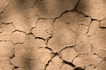 Wall texture soil dry crack pattern of drought lack of water of nature brown old broken background.