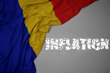 waving colorful national flag of romania on a gray background with broken text inflation. 3d illustration