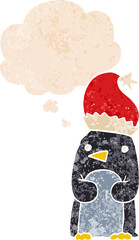 cute christmas penguin and thought bubble in retro textured style