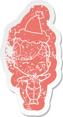 cartoon distressed sticker of a squinting girl wearing santa hat