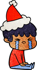 textured cartoon of a boy crying wearing santa hat