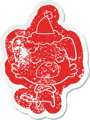 cartoon distressed sticker of a dog wearing santa hat