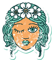 distressed sticker tattoo style icon of a maidens face winking