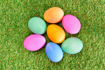 Fototapeta na wymiar Colored easter eggs on green grass in spring