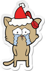 sticker cartoon of a cat wearing santa hat