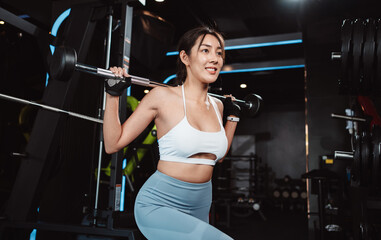 Plakat Woman working out Bodybuilder with barbell weights at the gym. bodybuilder doing exercises with barbell. training sport healthy lifestyle bodybuilding, Athlete builder muscles lifestyle.