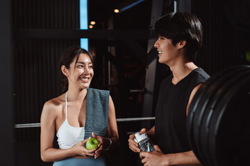 After Training of sportsman and sportswoman exercise workout in gym fitness breaking and resting after training sport with dumbbells healthy lifestyle bodybuilding.