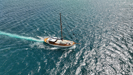 Fototapeta premium Aerial drone photo of wooden sail boat cruising deep blue Mediterranean sea