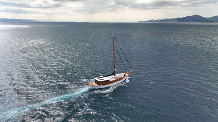 Fototapeta premium Aerial drone photo of wooden sail boat cruising deep blue Mediterranean sea