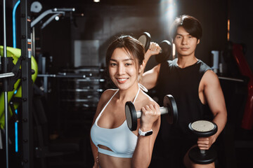After Training of sportsman and sportswoman exercise workout in gym fitness breaking and resting after training sport with dumbbells healthy lifestyle bodybuilding.