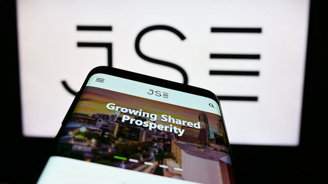 Stuttgart, Germany - 03-25-2023: Mobile phone with website of JSE Limited (Johannesburg Stock Exchange) on screen in front of business logo. Focus on top-left of phone display.