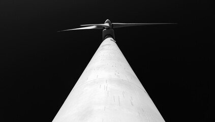 black and white image of the movement of the blades of a wind turbine driven by the wind in wind...