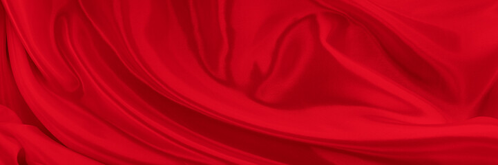 Black red satin dark fabric texture luxurious shiny that is abstract silk cloth background with patterns soft waves blur beautiful.
