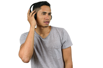28 year old Brazilian with wireless headphone, listening to music and looking to the side.