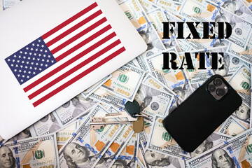 Fixed rate concept. USA flag, dollar money with keys, laptop and phone background.
