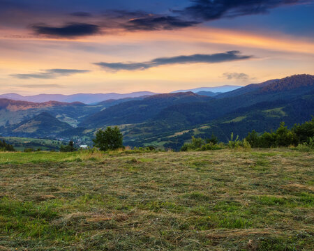 sunrise over rural valley and mountains. grassy fields and meadows on the hills