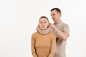Neurosurgeon puts cervical soft collar or neck brace bandage on young woman to support and immobilize neck or for treat traumatic head or neck injuries. Cervical collar.