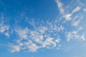 blue sky decorated with little clouds, horizontal scenery 
