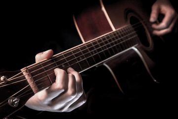 Fototapeta na wymiar close-up of the hands of a musician playing an acoustic guitar