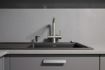 Faucet and granite sink in the kitchen