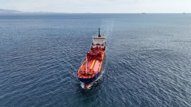 Aerial drone loop video of industrial liquified LPG gas tanker cruising deep blue Mediterranean sea