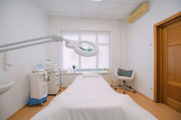 The interior of the massage and cometology salon, massage table. Nobody.