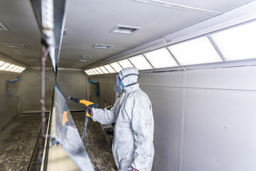 The craftsman paints structural elements in the painting box