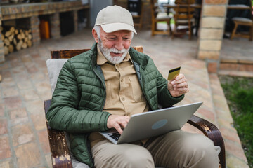Fototapeta premium Man senior caucasian male shopping online sit with laptop computer