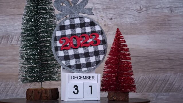 New Year's Day on December 31 on a white wooden calendar in a New Year's atmosphere. New year date 2023 and winter atmosphere. Wooden calendar with an important event.