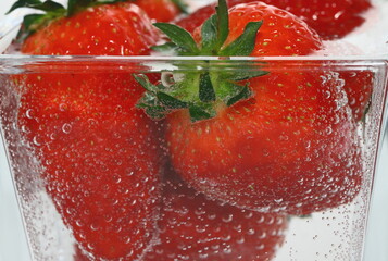 strawberries in a  glass, strawberries in water, air bubbles, delicious dessert, breakfast, vegan, vitamins, strawberry juice