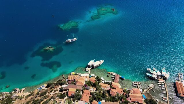 Drone footage of Simena Castle (Kalek&ouml;y), beach, and yachts, offering a unique perspective of the historic and natural beauty in Antalya, Turkey.