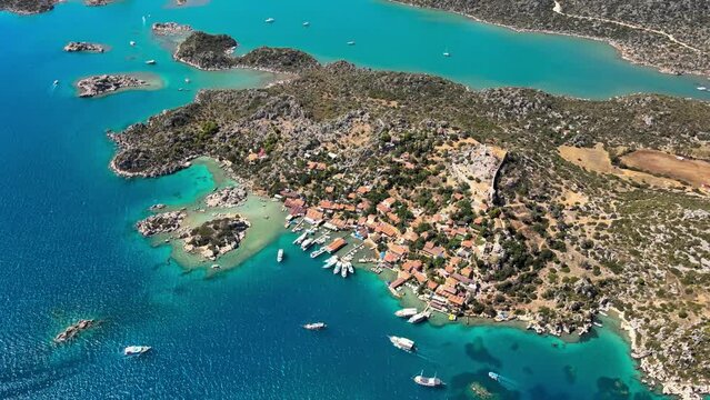 Drone video of Simena Castle (Kalek&ouml;y), beach, and yachts, providing an aerial perspective of the historic site and beautiful Mediterranean landscape in Antalya, Turkey.